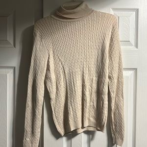 This is a cream colored top, that has been worn before but in good condition